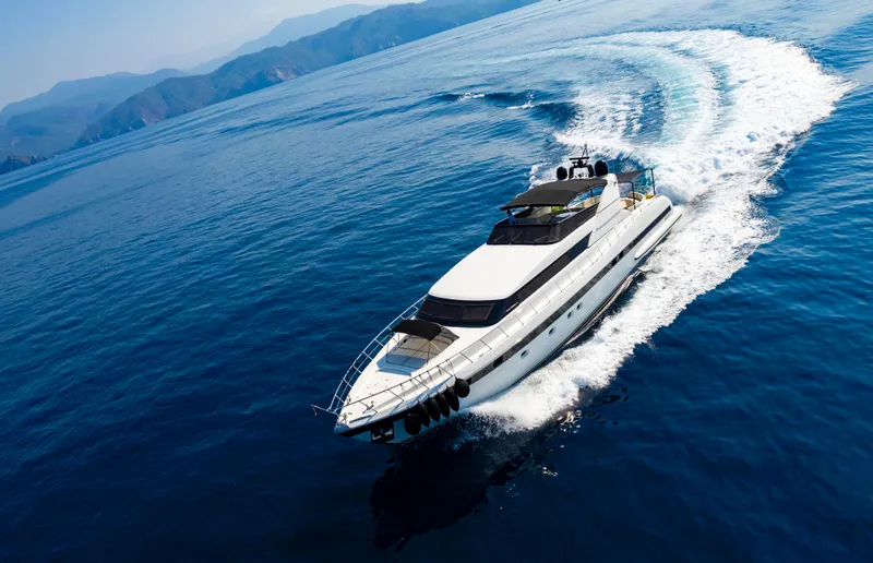  Yacht Photos Pics Luxurious 1999 Mangusta 105 yacht cruising on open blue sea.