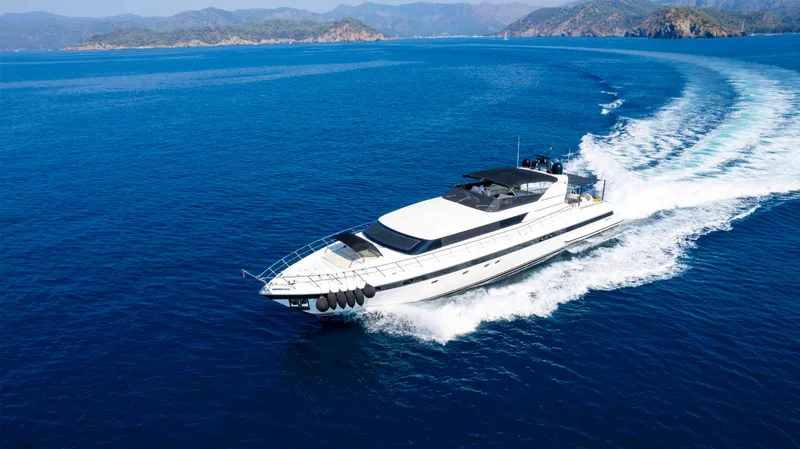  Yacht Photos Pics Luxurious 1999 Mangusta 105 yacht cruising on open blue sea.