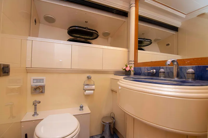  Yacht Photos Pics Luxurious bathroom in 1999 Mangusta 105 yacht with elegant fixtures and blue countertop.