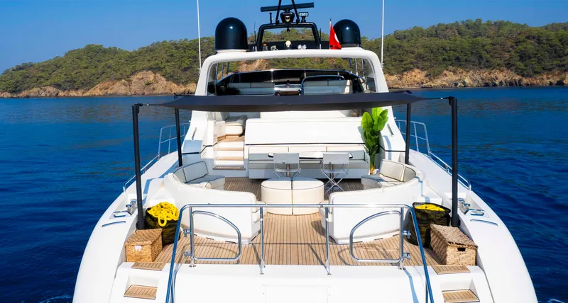  Yacht Photos Pics Luxurious 1999 Mangusta 105 yacht with spacious deck, scenic ocean view, and elegant seating.