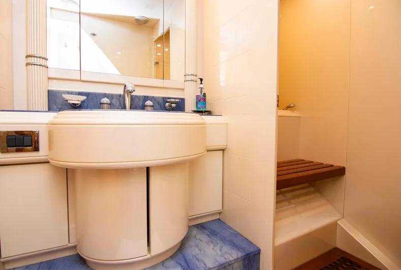  Yacht Photos Pics Luxurious bathroom in 1999 Mangusta 105 yacht with elegant sink and shower area.