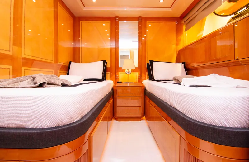  Yacht Photos Pics Luxurious twin cabin interior on 1999 Mangusta 105 yacht with warm wood finishes.