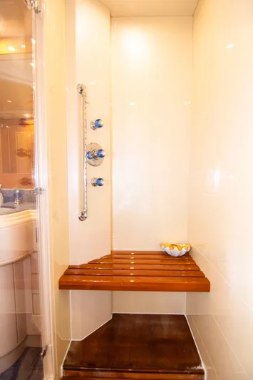  Yacht Photos Pics Shower area in 1999 Mangusta 105 yacht with wooden bench and modern fixtures.