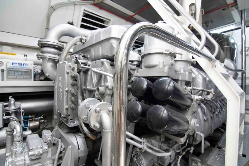  Yacht Photos Pics Engine room of a 1999 Mangusta 105 yacht, showcasing complex machinery and components.