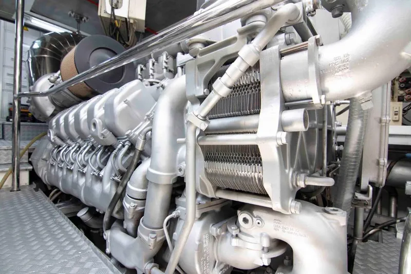  Yacht Photos Pics Engine room of a 1999 Mangusta 105 yacht, showcasing intricate machinery and components.