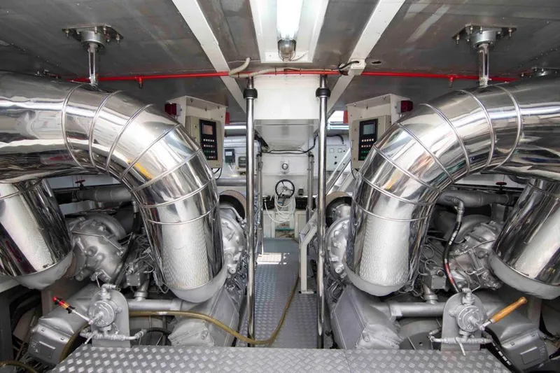  Yacht Photos Pics Engine room of 1999 Mangusta 105 yacht with polished metal pipes and machinery.