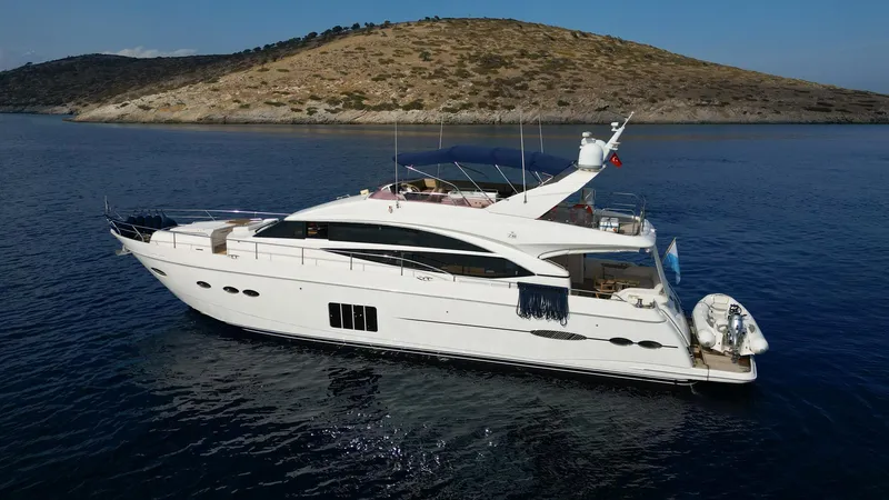  Yacht Photos Pics Luxurious 2012 Princess 72 yacht cruising on serene waters near a scenic island.