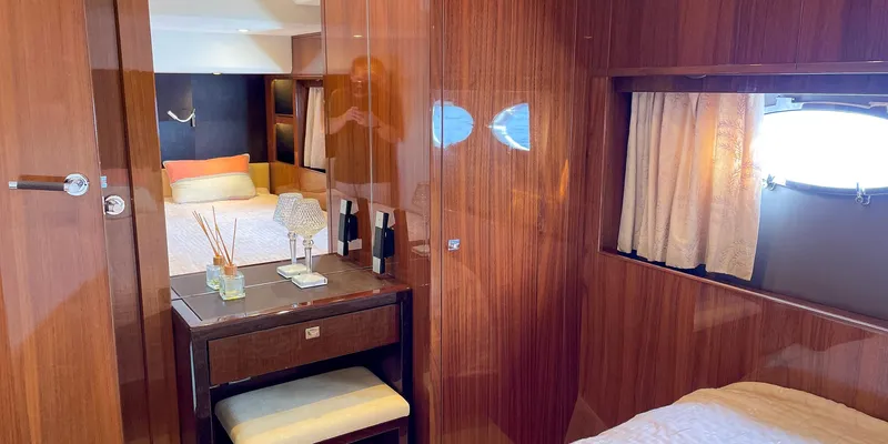  Yacht Photos Pics Luxurious interior of 2012 Princess 72 yacht with elegant wood finish and cozy bedding.