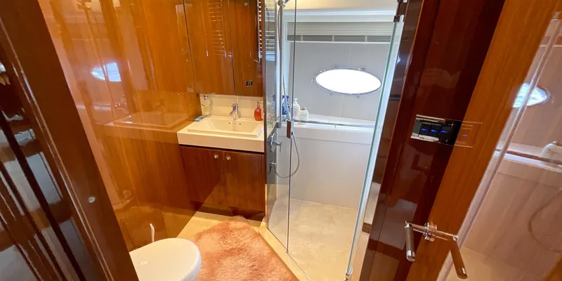  Yacht Photos Pics Luxurious bathroom in 2012 Princess 72 yacht with wood finishes and glass shower.