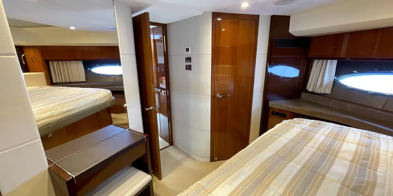  Yacht Photos Pics Luxurious interior of 2012 Princess 72 yacht with elegant wood finishes and cozy sleeping quarters.
