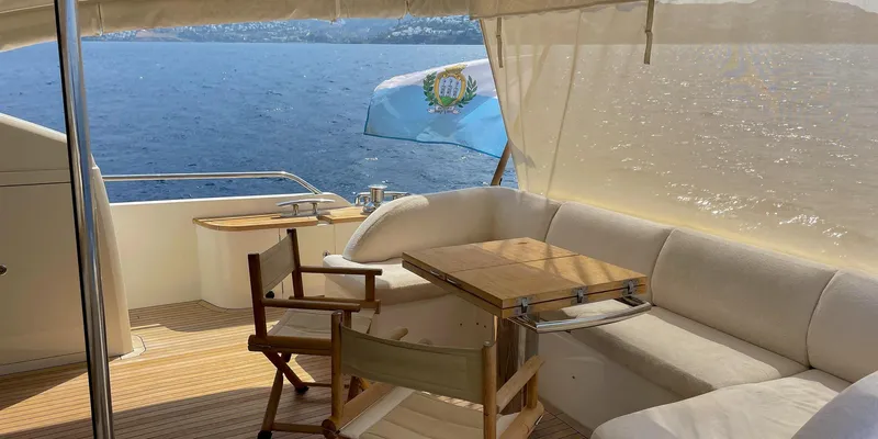  Yacht Photos Pics Luxurious 2012 Princess 72 yacht deck with seating, table, and ocean view.