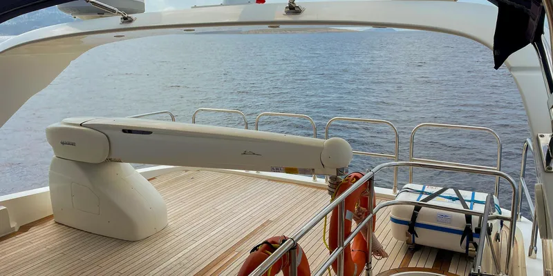  Yacht Photos Pics Luxury Princess 72 yacht deck with crane, overlooking serene ocean waters, 2012 model.