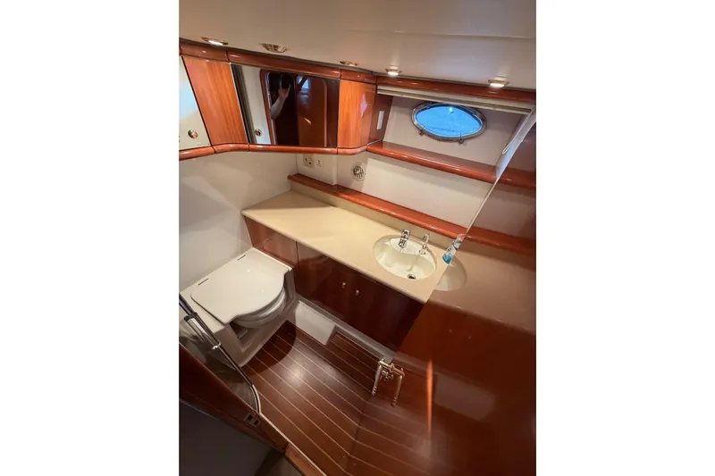What Is Life Yacht Photos Pics Luxurious bathroom in 2000 Sunseeker Manhattan 62 yacht with wood accents and porthole window.