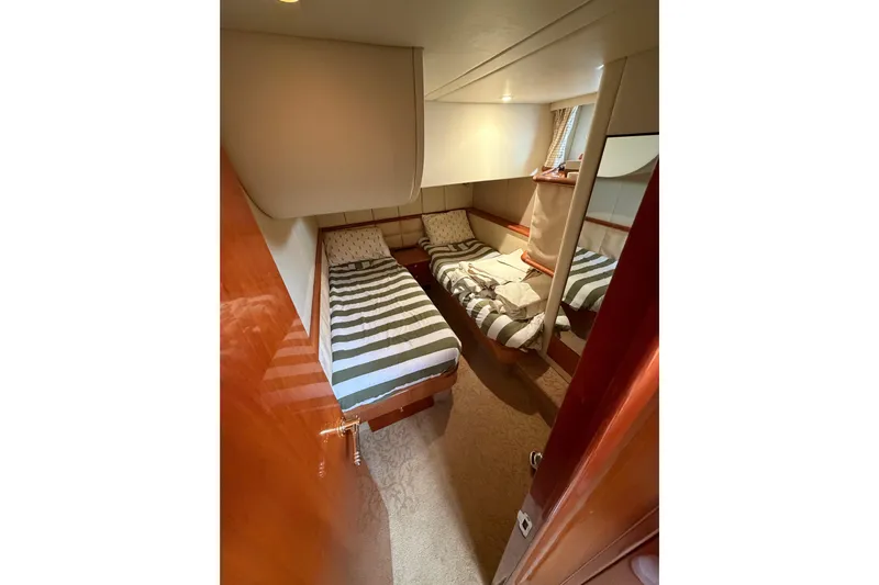 What Is Life Yacht Photos Pics Cozy twin cabin in 2000 Sunseeker Manhattan 62 yacht with striped bedding.