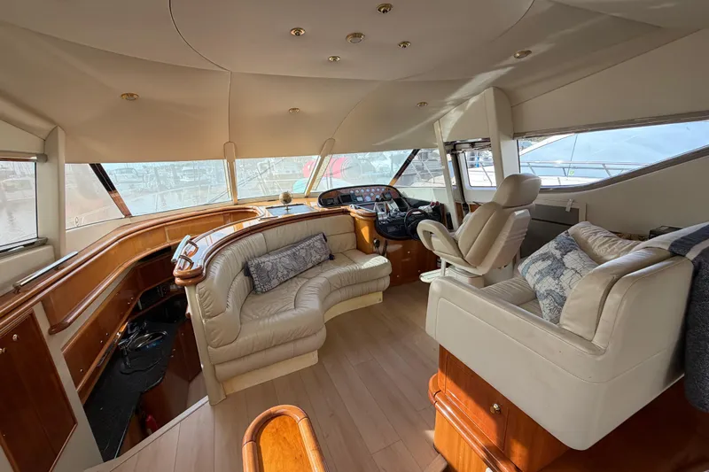 What Is Life Yacht Photos Pics Luxurious interior of a 2000 Sunseeker Manhattan 62 yacht with plush seating and helm.