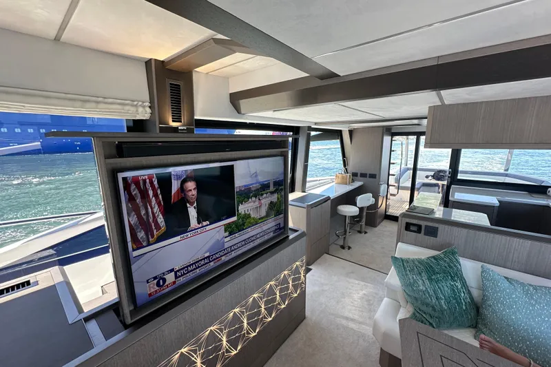 Yacht Photos Pics Luxurious interior of 2025 Galeon 640 Fly yacht with TV and waterfront view.