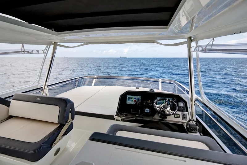  Yacht Photos Pics Luxurious 2025 Galeon 640 Fly yacht helm with ocean view, featuring modern navigation controls.