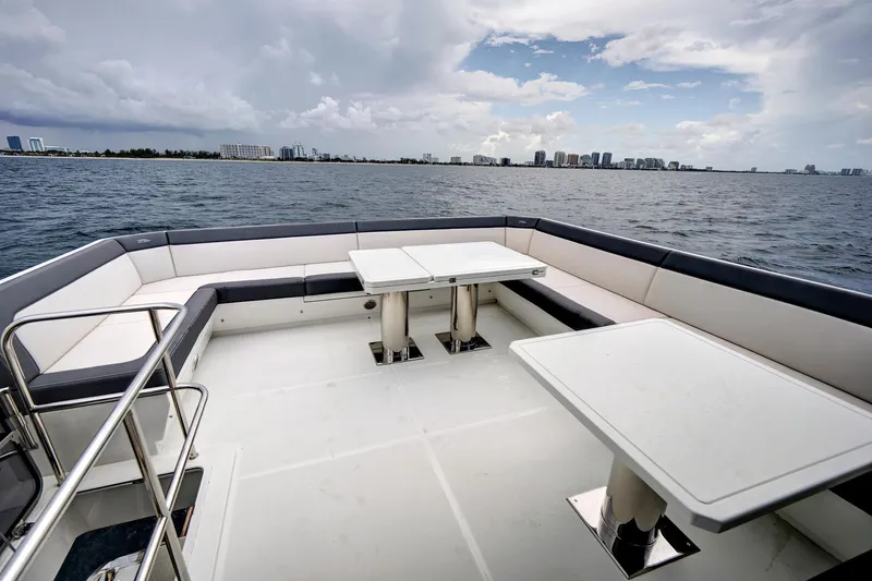  Yacht Photos Pics Luxurious 2025 Galeon 640 Fly yacht deck with seating and tables, overlooking the ocean.