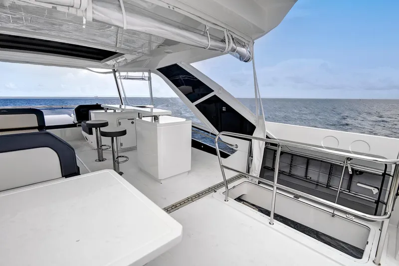  Yacht Photos Pics Luxurious 2025 Galeon 640 Fly yacht deck with ocean view, featuring modern seating and bar area.