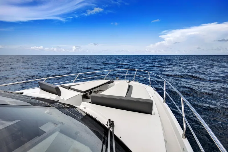  Yacht Photos Pics 2025 Galeon 640 Fly yacht cruising on open sea under clear blue sky.