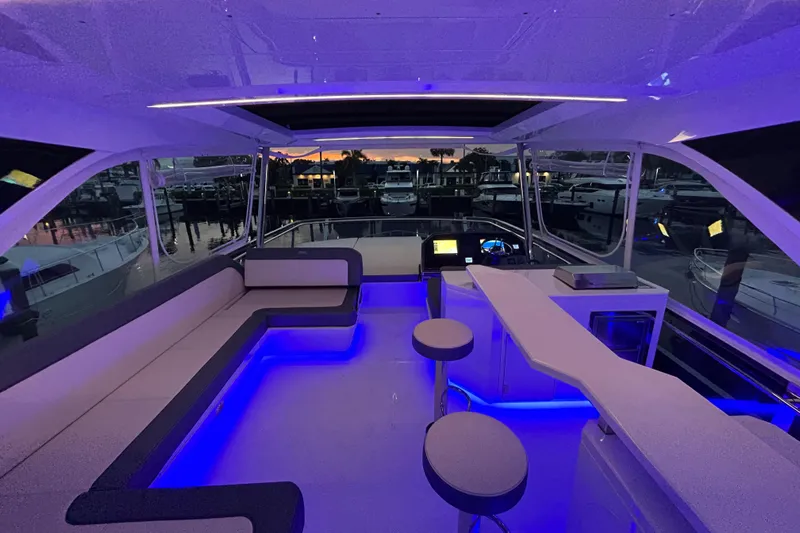  Yacht Photos Pics Luxurious interior of 2025 Galeon 640 Fly yacht with ambient blue lighting at sunset.