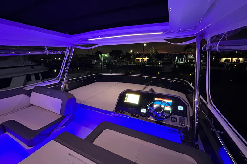  Yacht Photos Pics Luxurious 2025 Galeon 640 Fly yacht interior with illuminated helm and seating at night.