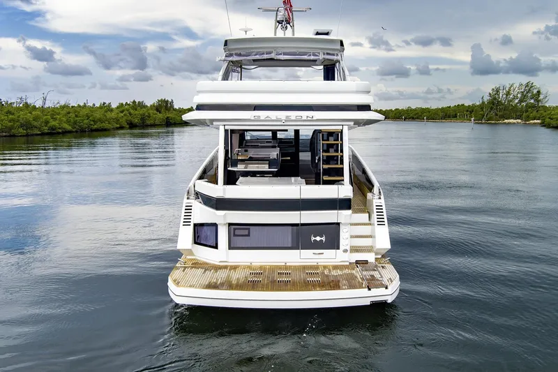  Yacht Photos Pics 2025 Galeon 640 Fly yacht on calm water, rear view, showcasing luxury design.