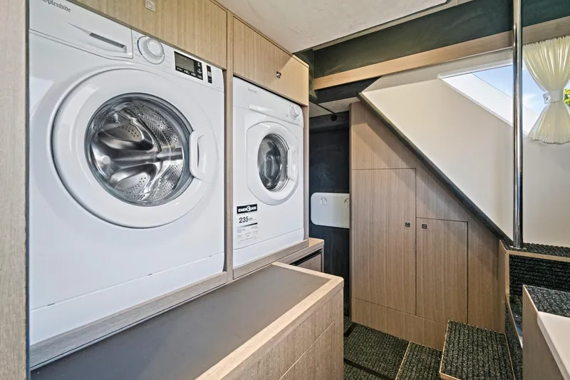  Yacht Photos Pics Laundry area inside 2025 Galeon 640 Fly yacht, featuring modern washing machines.