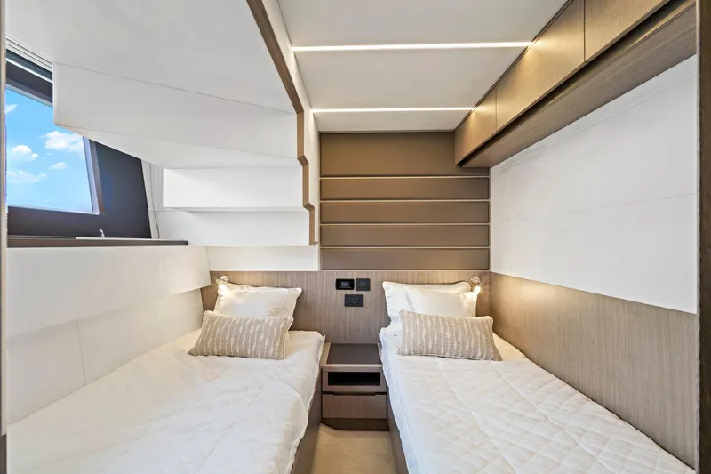  Yacht Photos Pics Luxurious twin cabin interior of 2025 Galeon 640 Fly yacht, featuring modern design and cozy bedding.