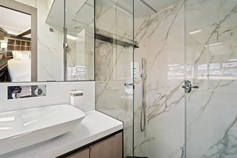  Yacht Photos Pics Luxurious bathroom in 2025 Galeon 640 Fly yacht with marble walls and modern fixtures.