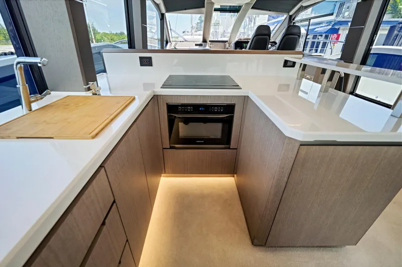  Yacht Photos Pics Modern kitchen interior of 2025 Galeon 640 Fly yacht with sleek design and appliances.
