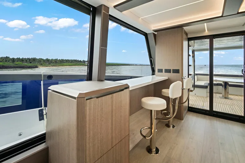  Yacht Photos Pics Luxurious interior of 2025 Galeon 640 Fly yacht with ocean view and modern bar seating.