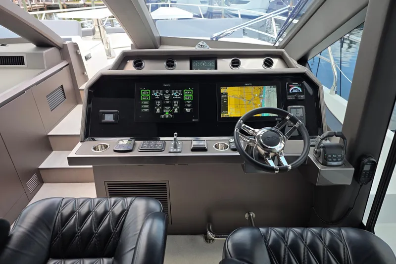  Yacht Photos Pics 2025 Galeon 640 Fly yacht cockpit with advanced navigation system and luxurious leather seating.