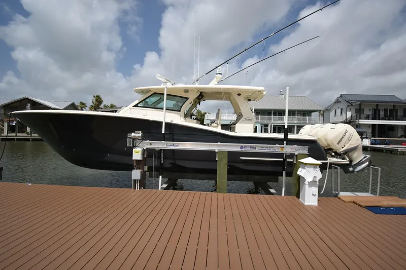  Yacht Photos Pics 2022 Scout 425 LXF boat docked, featuring sleek design and powerful engines.