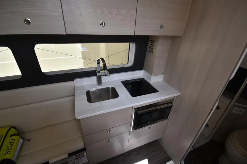  Yacht Photos Pics 2022 Scout 425 LXF interior kitchen with sink, stove, and microwave.