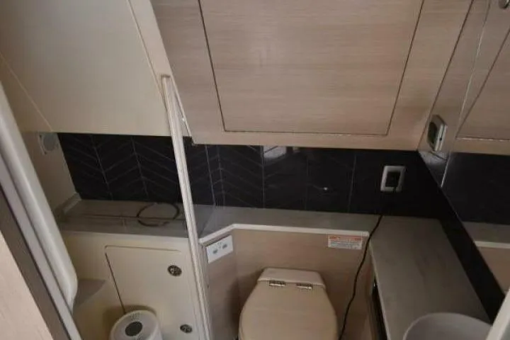  Yacht Photos Pics 2022 Scout 425 LXF boat bathroom interior with modern fixtures and wood accents.
