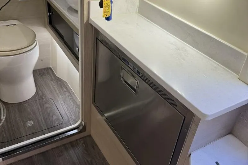  Yacht Photos Pics 2022 Scout 425 LXF boat interior with toilet and stainless steel cabinet.