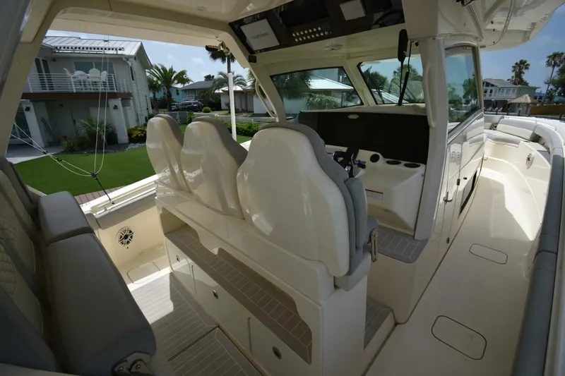  Yacht Photos Pics 2022 Scout 425 LXF boat interior with helm seats and modern dashboard.