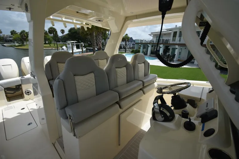  Yacht Photos Pics 2022 Scout 425 LXF boat interior with luxurious seating and modern helm controls.