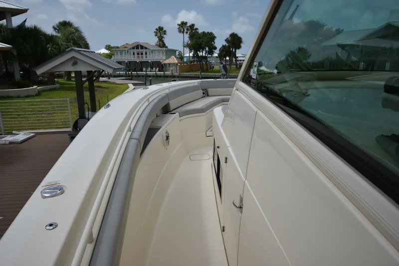  Yacht Photos Pics 2022 Scout 425 LXF boat docked, showcasing sleek design and spacious deck.