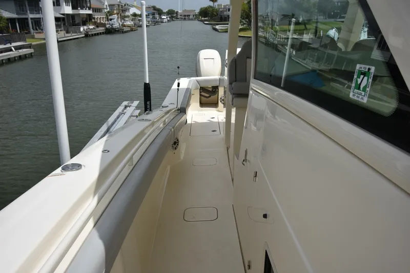  Yacht Photos Pics 2022 Scout 425 LXF boat docked in a scenic waterfront setting.