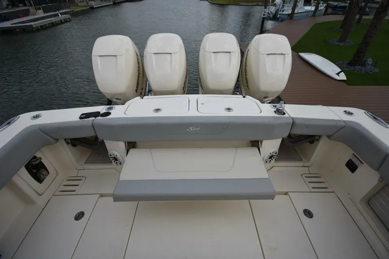  Yacht Photos Pics 2022 Scout 425 LXF boat with four powerful outboard engines docked by the water.