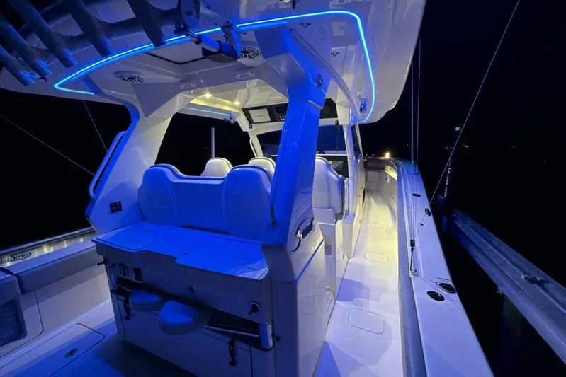  Yacht Photos Pics 2022 Scout 425 LXF boat interior with blue LED lighting at night.