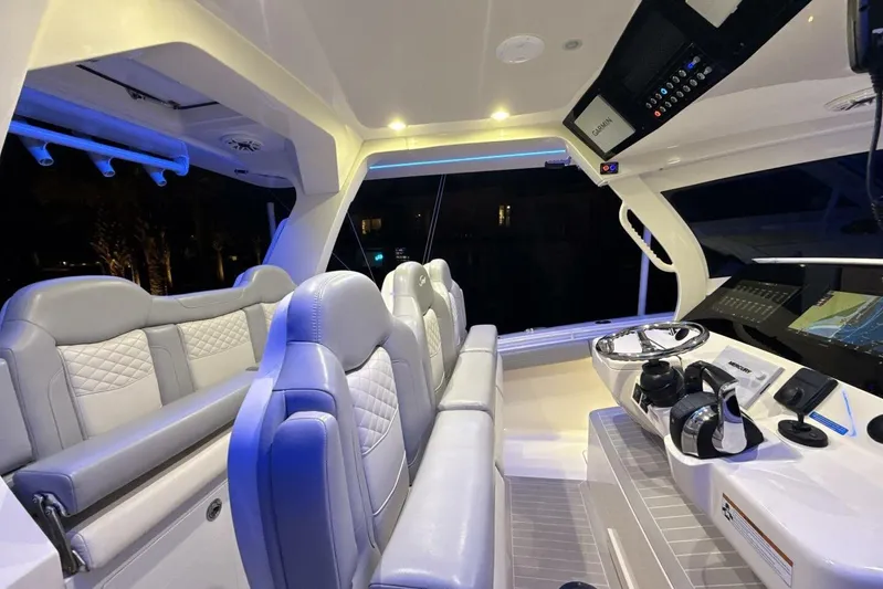  Yacht Photos Pics Luxurious interior of 2022 Scout 425 LXF boat with modern seating and advanced navigation system.