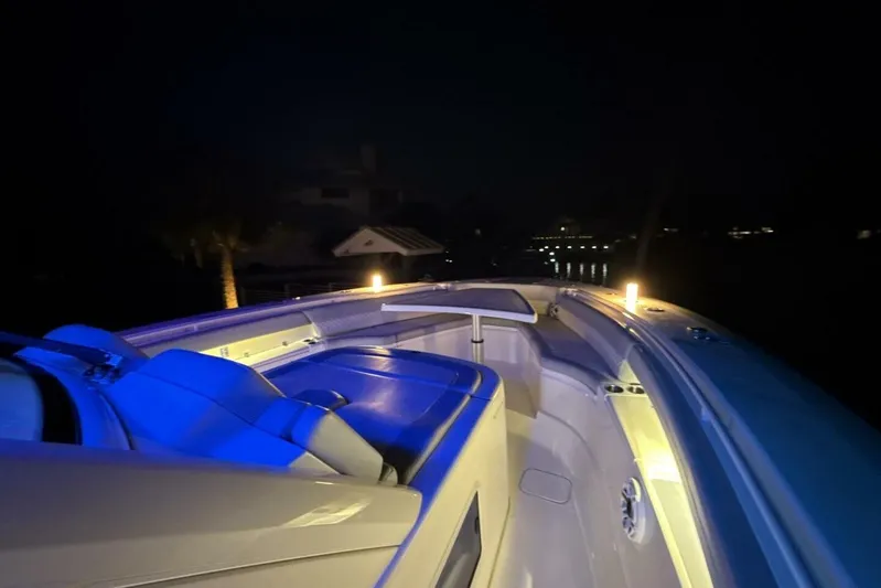  Yacht Photos Pics 2022 Scout 425 LXF boat interior illuminated at night with blue and yellow lights.