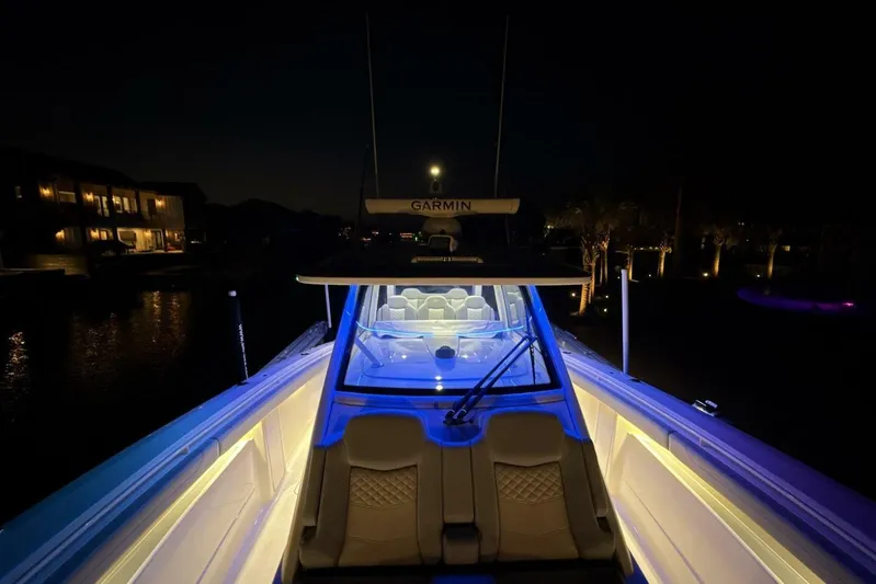  Yacht Photos Pics 2022 Scout 425 LXF boat illuminated at night with ambient lighting.