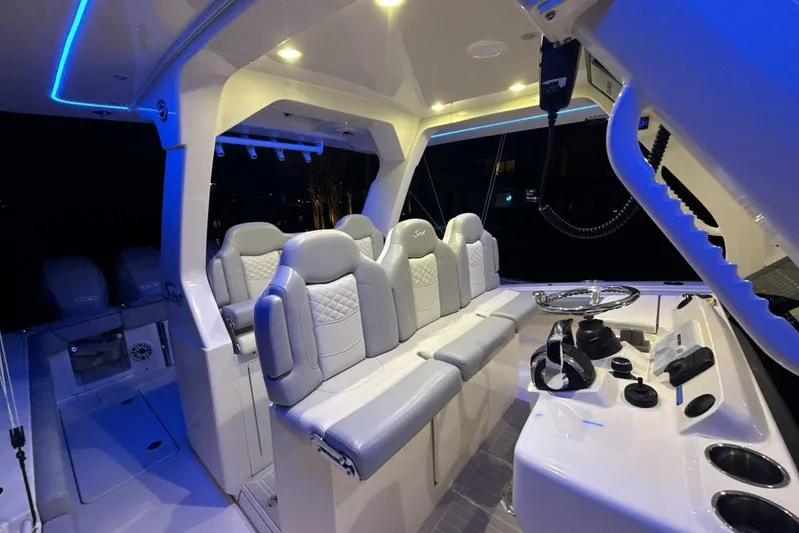  Yacht Photos Pics 2022 Scout 425 LXF boat interior with illuminated seating and modern helm controls.