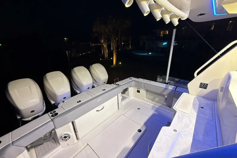  Yacht Photos Pics 2022 Scout 425 LXF boat interior with multiple outboard engines at night.