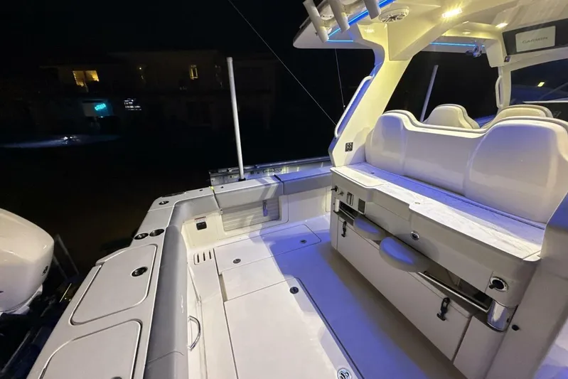  Yacht Photos Pics 2022 Scout 425 LXF boat interior with illuminated seating and modern design at night.