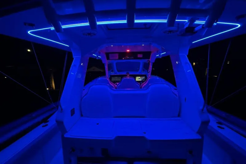  Yacht Photos Pics 2022 Scout 425 LXF boat interior with blue LED lighting at night.